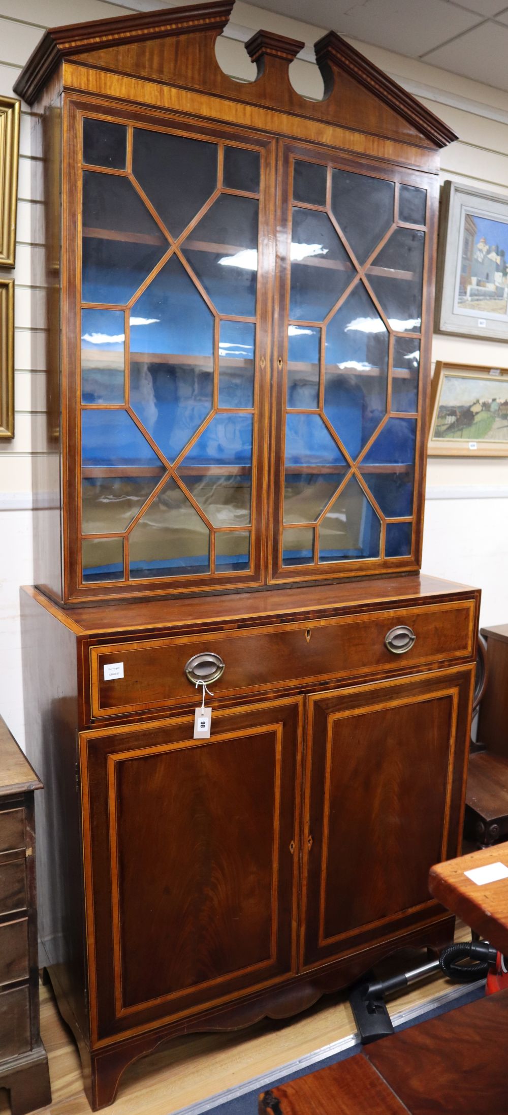 A George III and later mahogany, satinwood banded bookcase cabinet, W.107cm, D.51cm, H.246cm